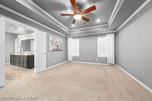 interior space featuring a tray ceiling, ceiling fan, and ornamental molding