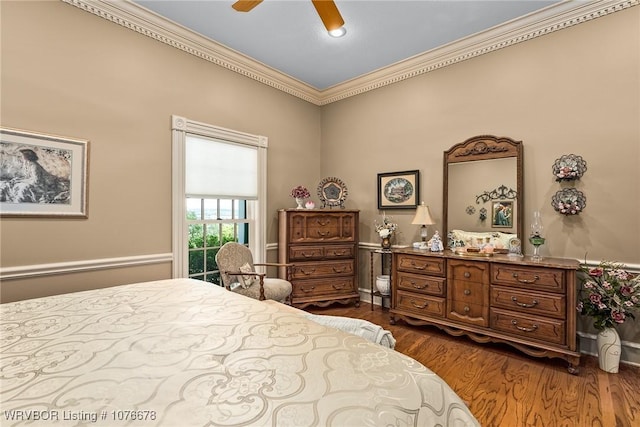 bedroom with ceiling fan, dark hardwood / wood-style floors, and ornamental molding