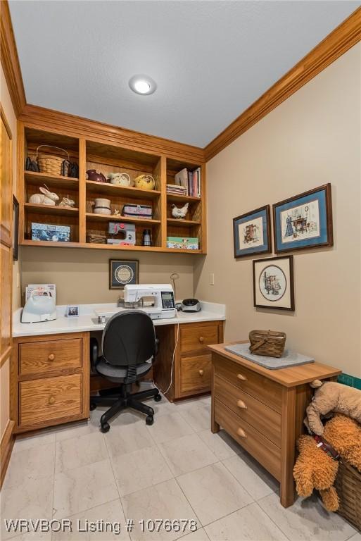 office with crown molding and built in desk