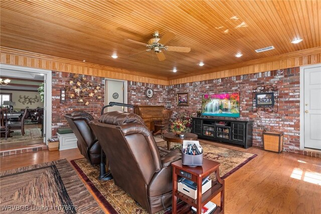 living room with ceiling fan, wooden ceiling, and brick wall