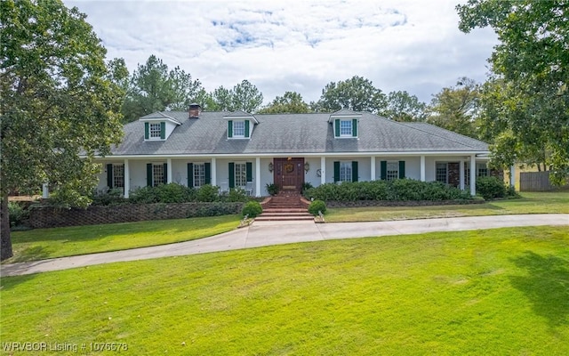 cape cod-style house featuring a front lawn