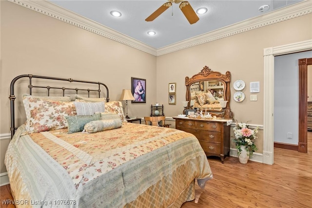 bedroom featuring ceiling fan, light hardwood / wood-style floors, and crown molding