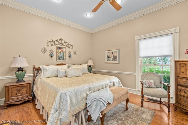 bedroom with light hardwood / wood-style floors, ceiling fan, and ornamental molding