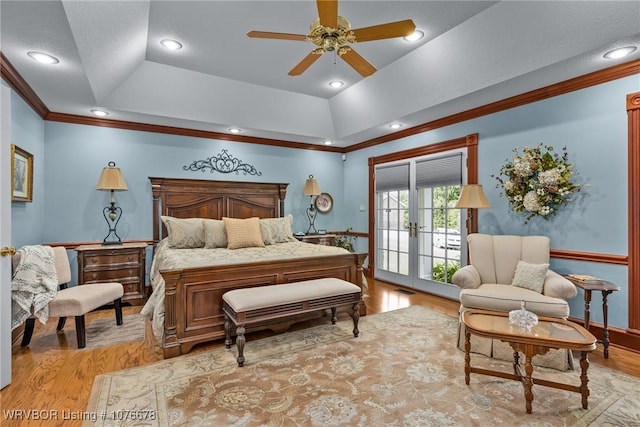 bedroom with access to outside, french doors, ceiling fan, light wood-type flooring, and a tray ceiling