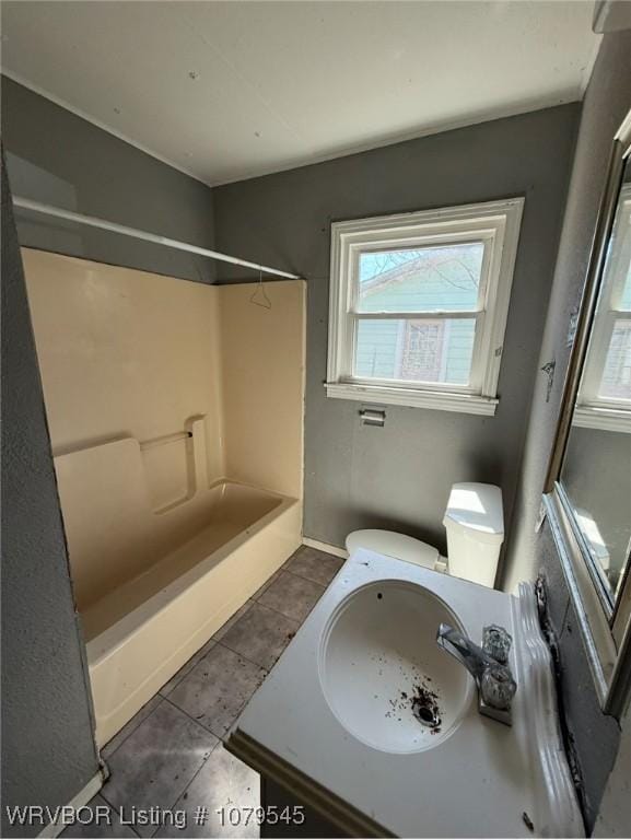 bathroom featuring vanity, tile patterned floors, toilet, and bathtub / shower combination