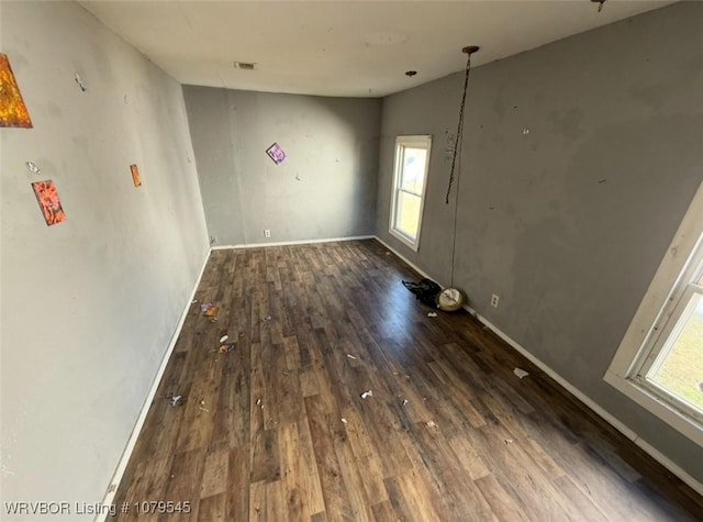 interior space with visible vents, baseboards, and wood finished floors