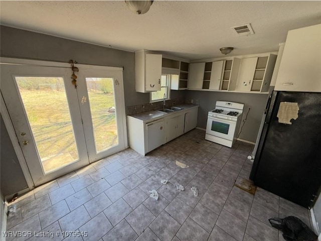 kitchen with visible vents, open shelves, a sink, white cabinetry, and white appliances