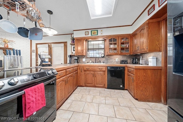 kitchen featuring decorative light fixtures, sink, decorative backsplash, ornamental molding, and black appliances