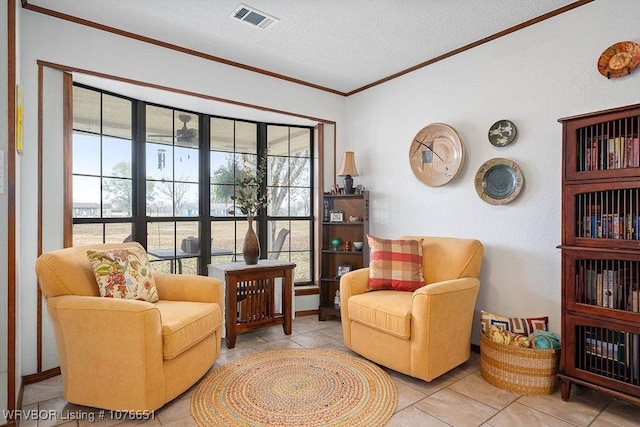 sitting room featuring a wealth of natural light, a textured ceiling, and light tile patterned floors