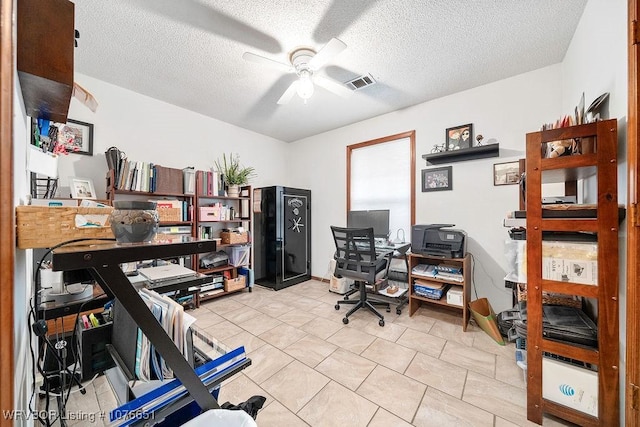 office featuring ceiling fan, light tile patterned floors, and a textured ceiling