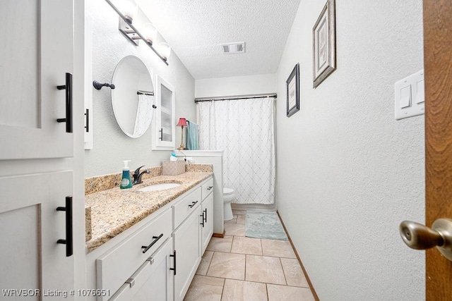 bathroom featuring vanity, a textured ceiling, a shower with curtain, tile patterned floors, and toilet