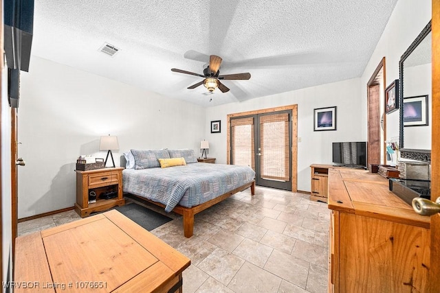 tiled bedroom with access to exterior, a textured ceiling, french doors, and ceiling fan