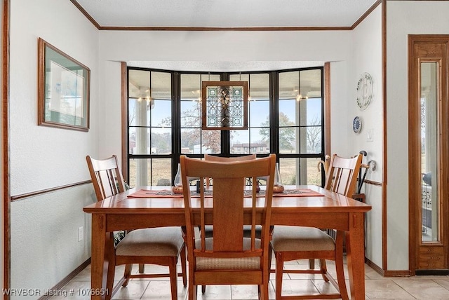 tiled dining room featuring crown molding