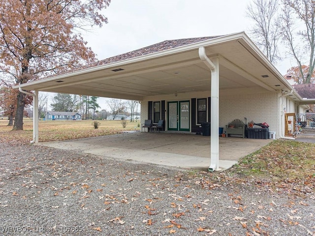 view of vehicle parking featuring a carport and french doors