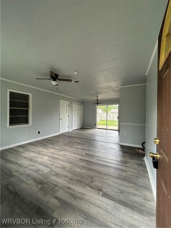 614 N School St, Charleston, AR 72933 - spare room featuring ornamental molding, ceiling fan, dark wood-style flooring, a textured ceiling, and baseboards