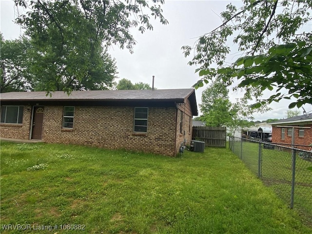 614 N School St, Charleston, AR 72933 - back of property with brick siding and central AC