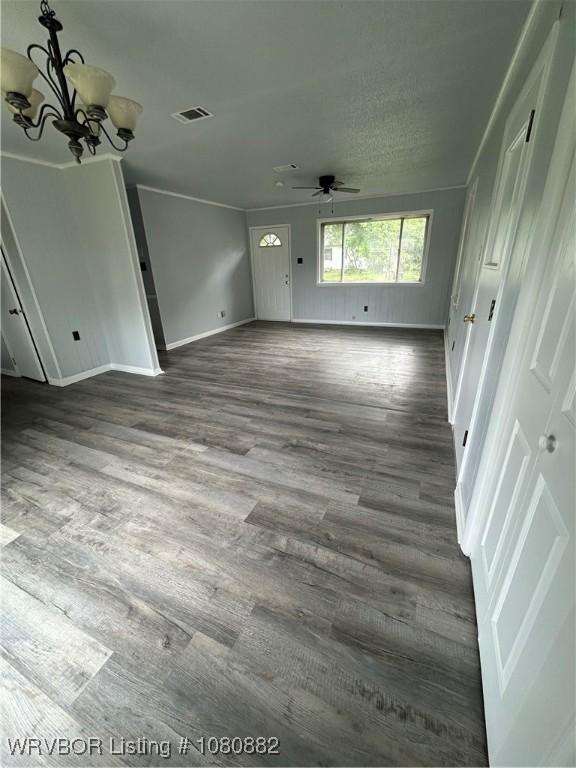 614 N School St, Charleston, AR 72933 - unfurnished living room with ceiling fan, a chandelier, wood finished floors, baseboards, and ornamental molding