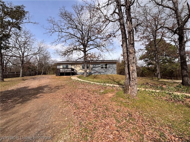 view of front facade featuring stone siding and a deck