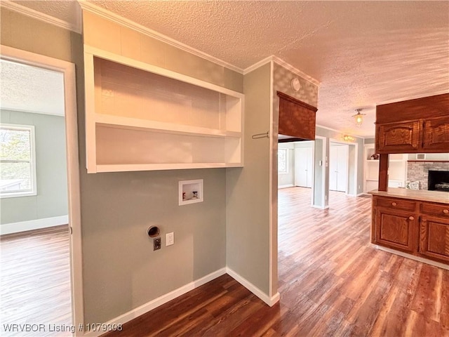 laundry area with laundry area, dark wood finished floors, hookup for a washing machine, a textured ceiling, and electric dryer hookup