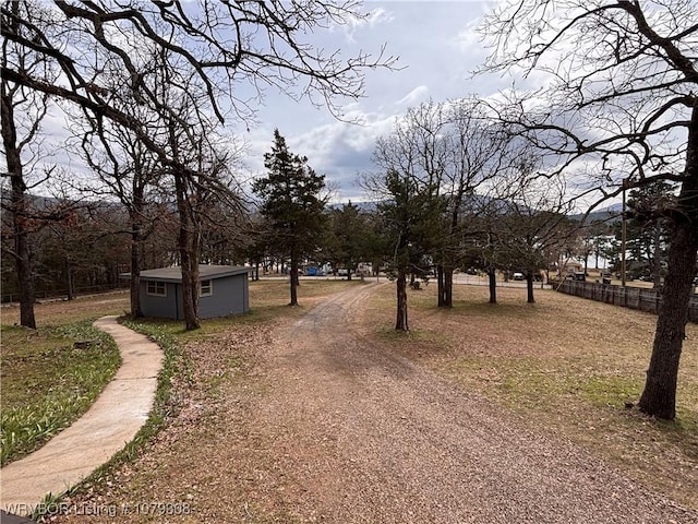 view of street with dirt driveway