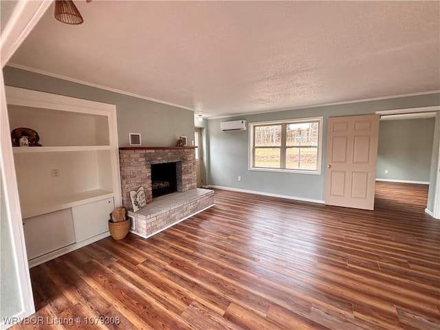 unfurnished living room with a fireplace, dark wood finished floors, visible vents, a wall mounted AC, and ornamental molding