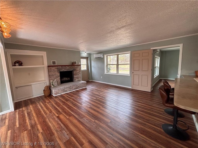 unfurnished living room featuring crown molding, a wall unit AC, dark wood finished floors, and a textured ceiling