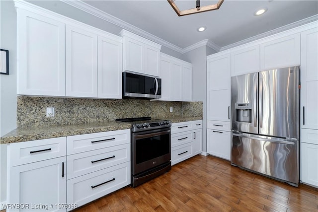 kitchen with tasteful backsplash, white cabinetry, light stone countertops, and stainless steel appliances