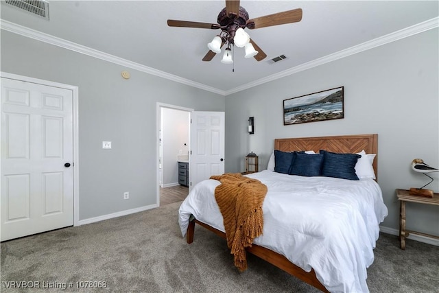 bedroom featuring ceiling fan, carpet floors, crown molding, and ensuite bath