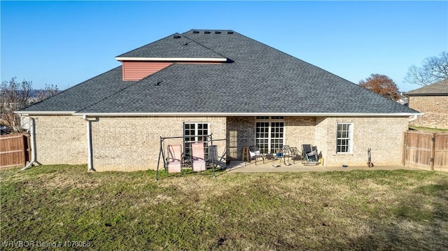 rear view of property with a lawn and a patio