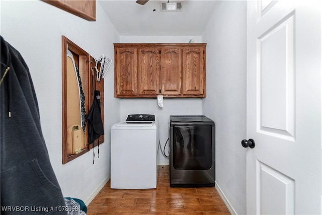 laundry room featuring cabinets, wood-type flooring, separate washer and dryer, and ceiling fan