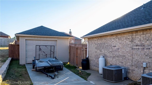 exterior space featuring a garage and central air condition unit