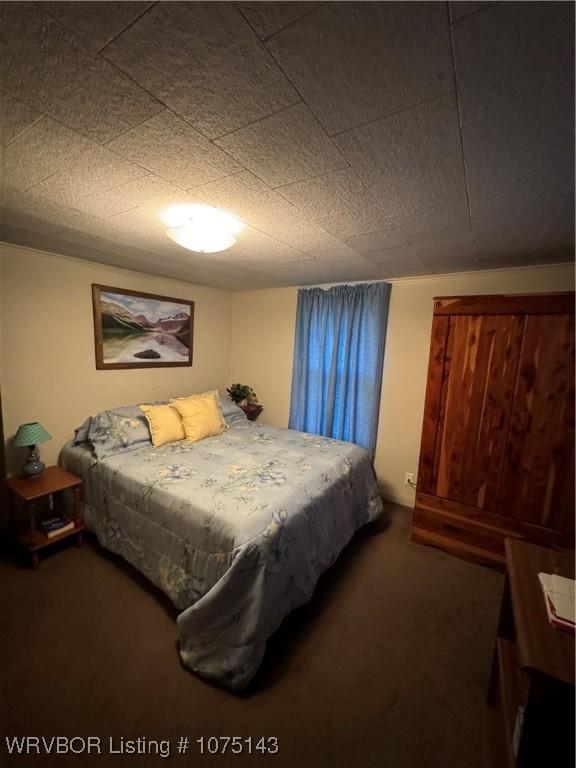 bedroom with dark colored carpet