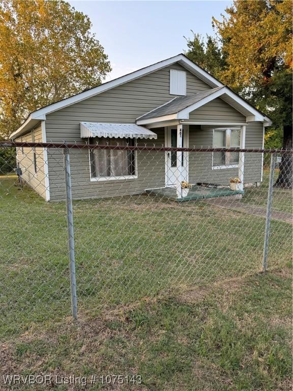 bungalow-style home with a front yard