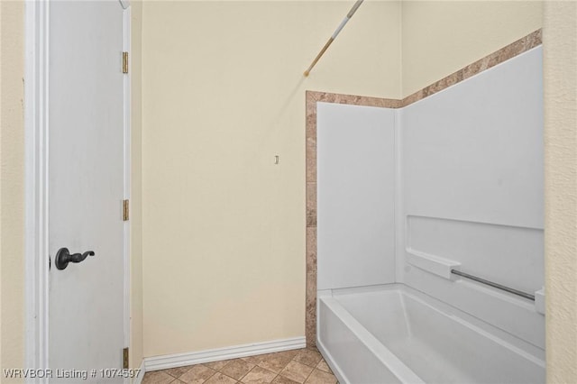 bathroom with tile patterned flooring and shower / tub combination