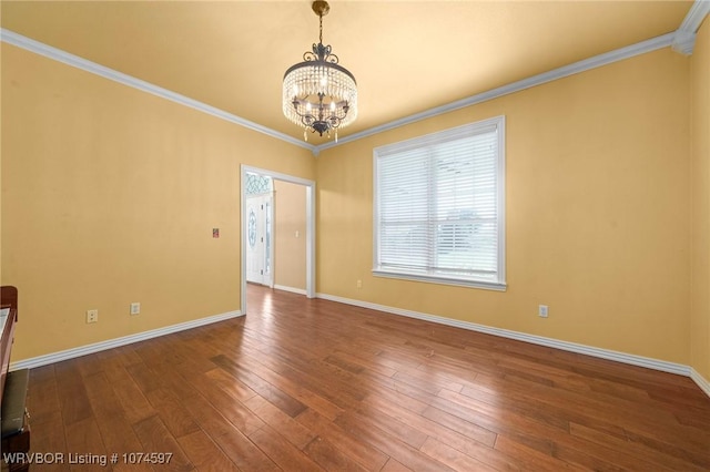 unfurnished room with a chandelier, hardwood / wood-style flooring, and ornamental molding