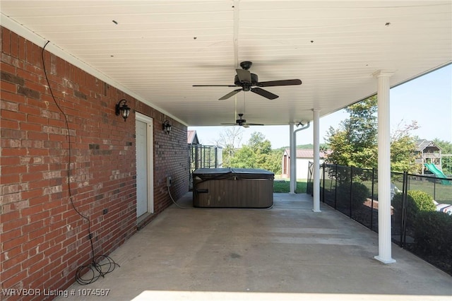 view of patio with ceiling fan and a hot tub