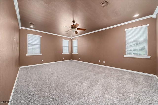 unfurnished room with carpet flooring, a healthy amount of sunlight, and ornamental molding