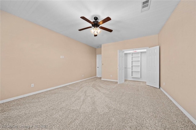 unfurnished bedroom with ceiling fan, a closet, and light carpet