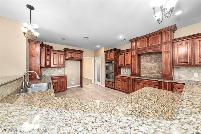 kitchen featuring sink, a notable chandelier, double oven, decorative backsplash, and light tile patterned flooring