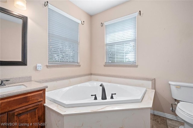 bathroom with a bathing tub, vanity, and toilet