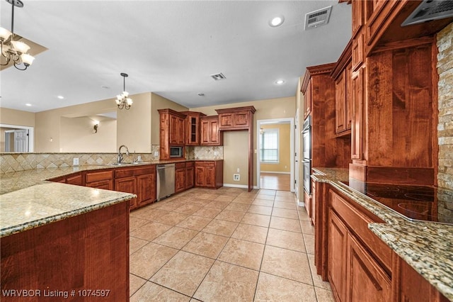 kitchen featuring appliances with stainless steel finishes, tasteful backsplash, and a notable chandelier