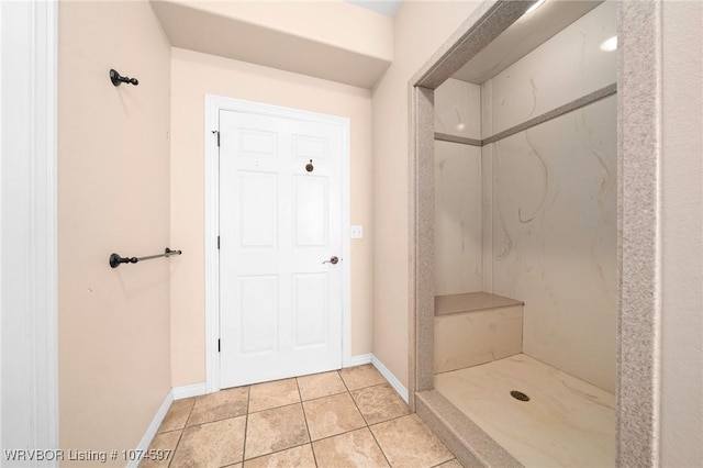 bathroom with tile patterned flooring and walk in shower