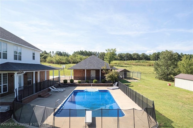 view of pool featuring a yard, an outbuilding, and a patio