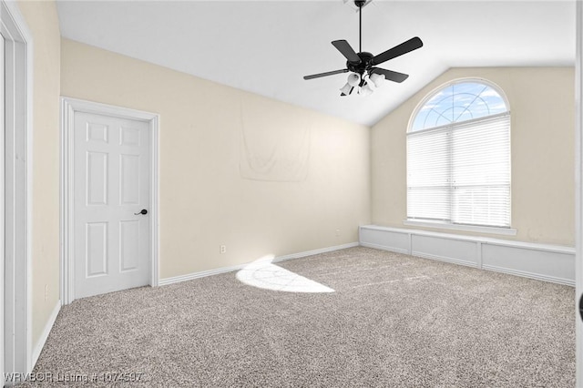 carpeted empty room featuring ceiling fan and lofted ceiling