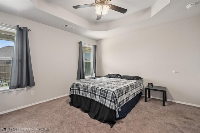 1138 Delta Dr, Van Buren, AR 72956 - carpeted bedroom featuring a tray ceiling and ceiling fan