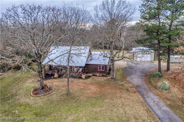 view of front of home with a front lawn, an outdoor structure, and a garage