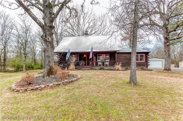 log cabin featuring a garage, a front lawn, an outdoor structure, and covered porch