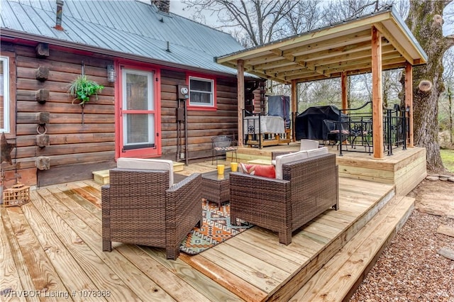 wooden deck featuring an outdoor hangout area and a grill