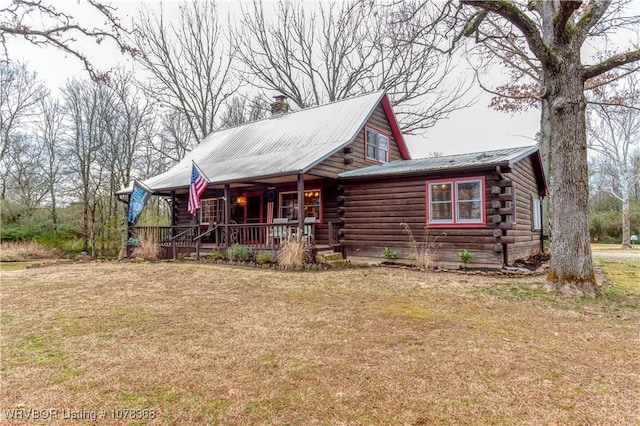 log cabin with a front lawn and a porch