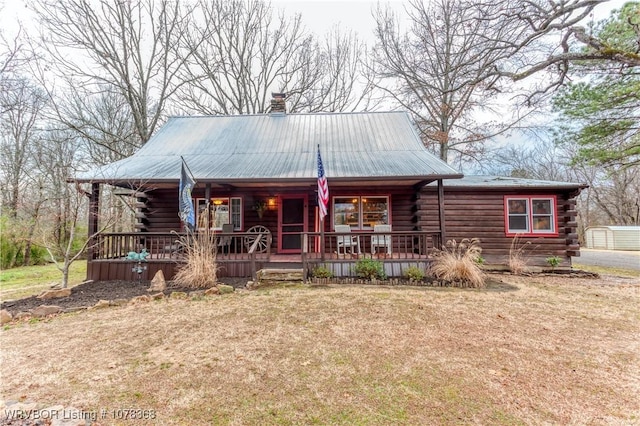 log home featuring a front yard and a porch